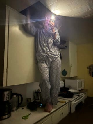Jane Twerler arrives in the attic while standing on the kitchen contrathe above the floodwater